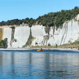 Rafting group approaching towering white cliffs along the Rangitikei River