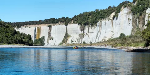 Rafting group approaching towering white cliffs along the Rangitikei River