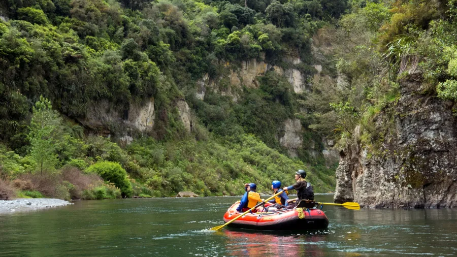 Family rafting through lush green gorges on the Scenic Rangitikei Rafting Tour