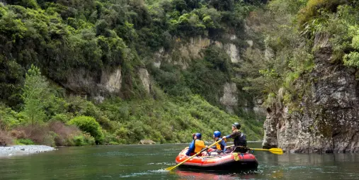 Family rafting through lush green gorges on the Scenic Rangitikei Rafting Tour
