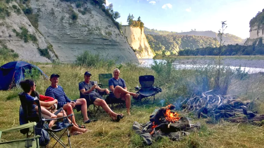 Group enjoying a riverside campfire on the Epic Rangitikei rafting tour