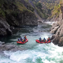 Two rafts prepare to descend Dog's Leg, the longest commercially run rapid on the Rangitikei River in New Zealand