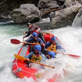 Rafting team led by guide plunges into a rapid on a River Valley Adventures white water tour