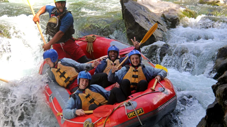 Excited rafting group dropping into a rapid on the Rangitikei River in New Zealand