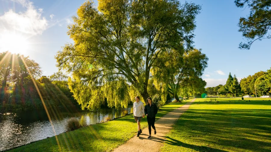 Couple walking beside Hokowhitu Lagoon in Palmerston North
