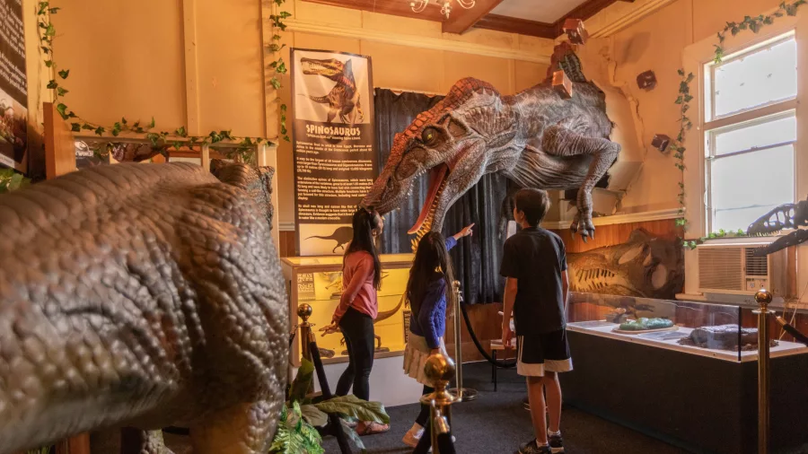 Children admiring a spinosaurus exhibit at Dinosaur House in Raetihi