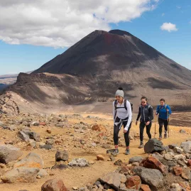 Hikers trekking the Tongariro Alpine Crossing with Mt Ngāuruhoe