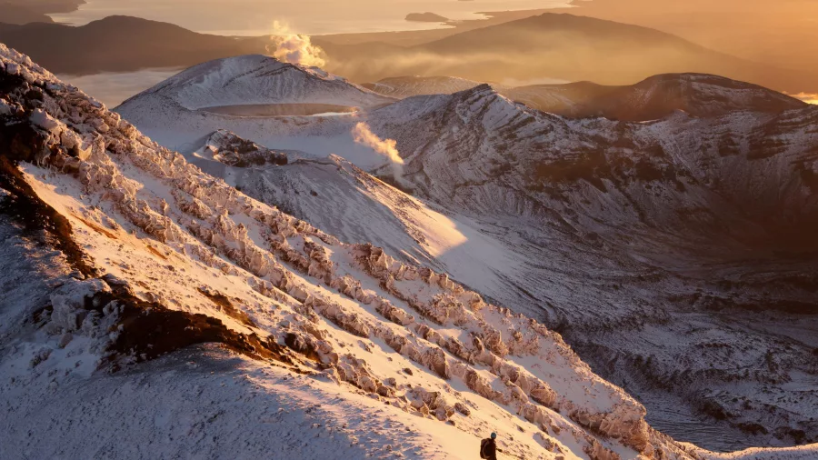 Solo hiker at sunrise on Mt Ngāuruhoe during Tongariro Alpine Crossing