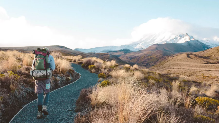 Backpacker on Tongariro Northern Circuit with large multi‑day pack