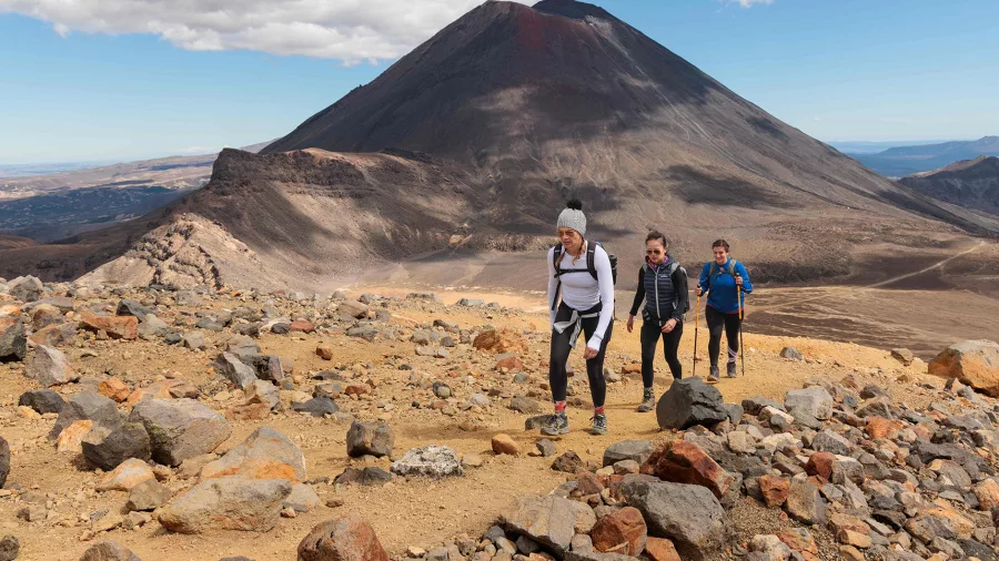 Hikers trekking the Tongariro Alpine Crossing with Mt Ngāuruhoe