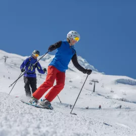Skiers carving down the slopes at Tūroa, Mt Ruapehu