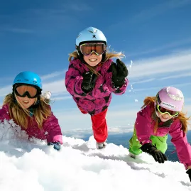 Three children playing in snow at Tūroa Ski Field, Mt Ruapehu