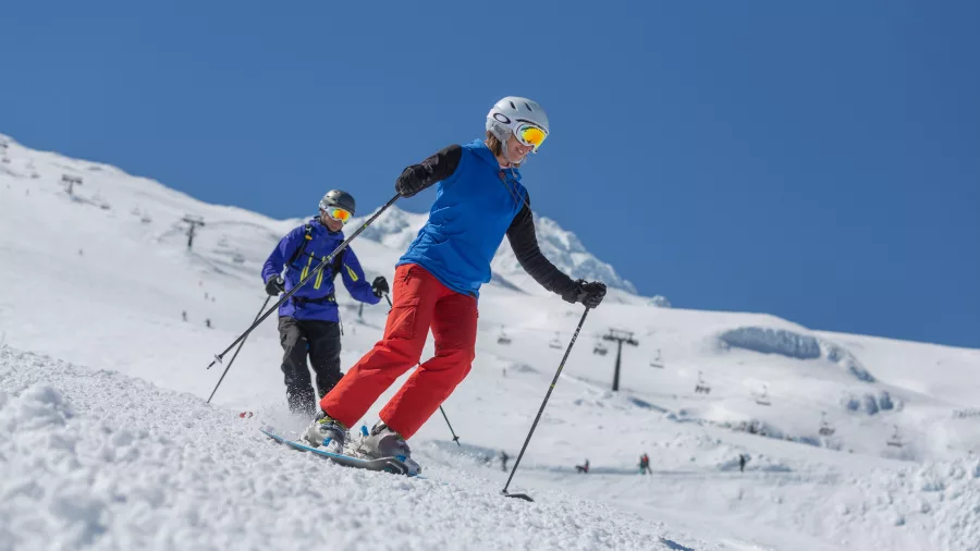 Skiers carving down the slopes at Tūroa, Mt Ruapehu