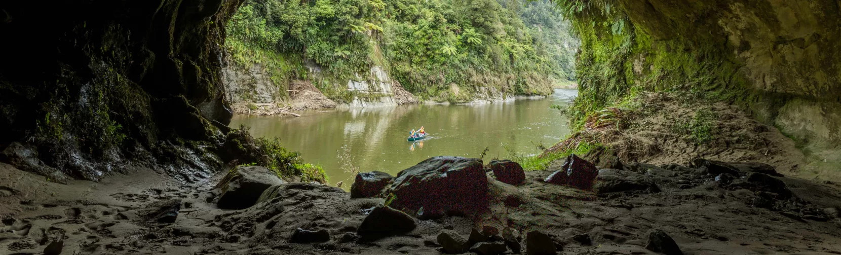 Canoe on the Whanganui River seen from inside Tematea’s Cave