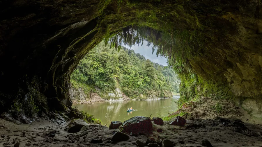 Canoe on the Whanganui River seen from inside Tematea’s Cave