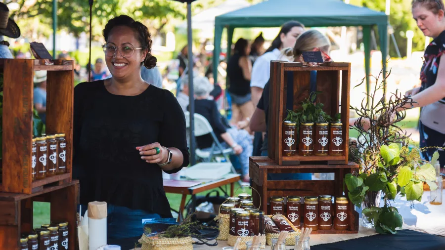 Stallholder selling local honey at Te Pātaka o Wairau Night Market in Blenheim, Marlborough