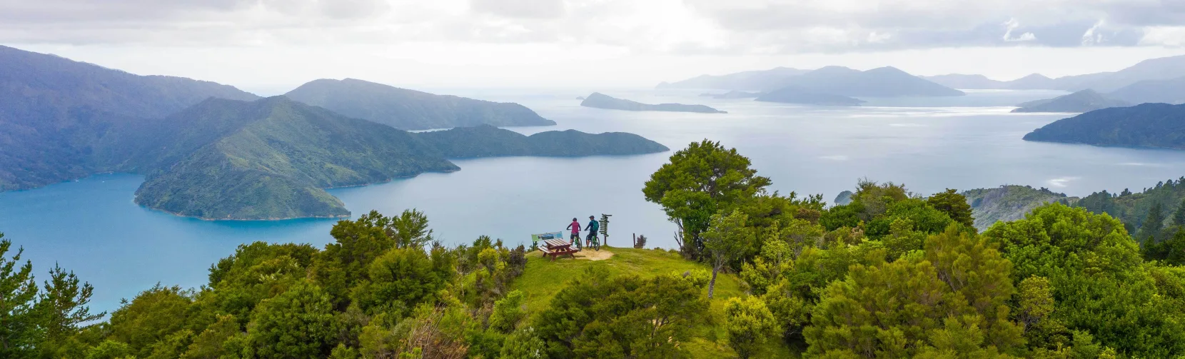 Aerial view of cyclists at Eatwell’s Lookout with sweeping views of the Marlborough Sounds