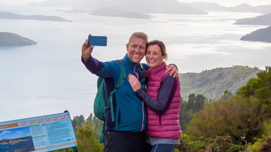 Couple taking a selfie at Eatwell’s Lookout with views over the Marlborough Sounds