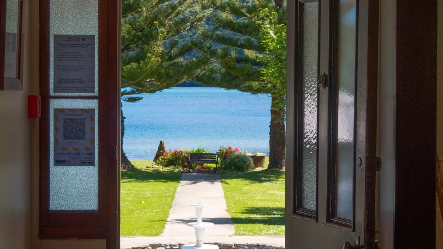 View to the bay from inside a luxury suite at Furneaux Lodge