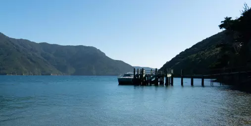 Clear water and rocky shoreline leading to the Kaipupu Wildlife Sanctuary jetty.