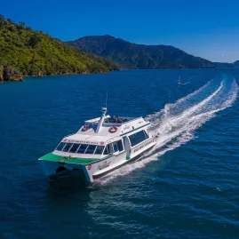 Beachcomber Cruises mail boat speeding across Queen Charlotte Sound on a sunny day.
