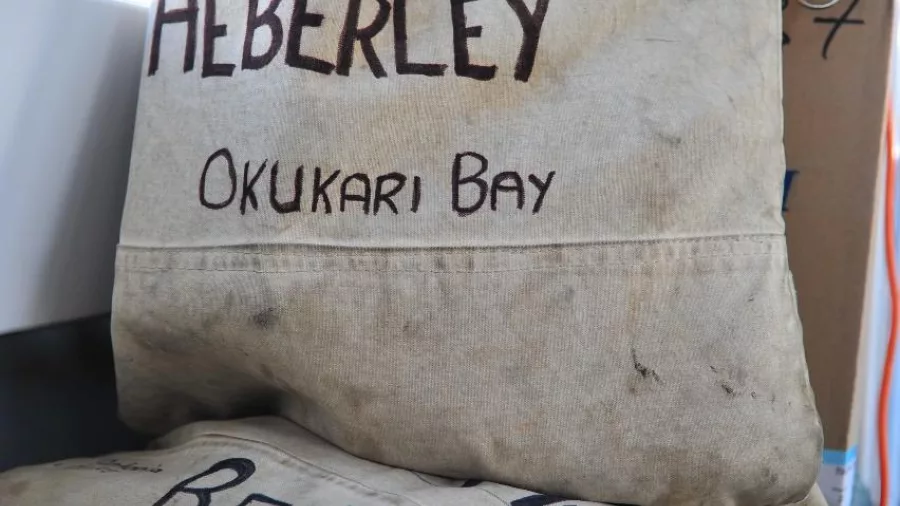 Close-up of canvas mailbags labelled for remote bays on the Beachcomber Mailboat.