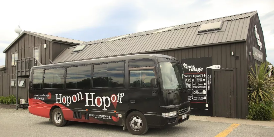 Hop On Hop Off wine tour bus parked at The Vines Village in Marlborough