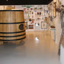 Large wine barrel and historic winemaking tools on display at Marlborough Museum