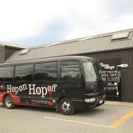 Hop On Hop Off wine tour bus parked at The Vines Village in Marlborough