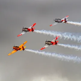 Four vintage warbirds flying in tight formation at Classic Fighters Omaka Air Show