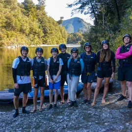 Group of kayakers standing on the banks of the Pelorus River before a Hobbit Kayak Tour
