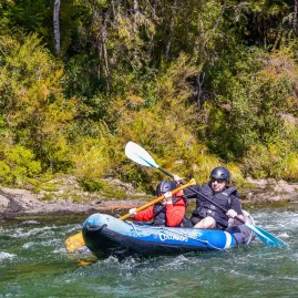 Father and son kayaking through a bend on the Pelorus River during a Hobbit-themed tour