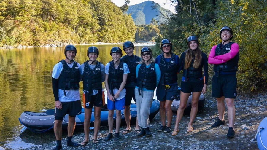 Group of kayakers standing on the banks of the Pelorus River before a Hobbit Kayak Tour