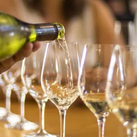 White wine being poured into tasting glasses during a Marlborough wine tour