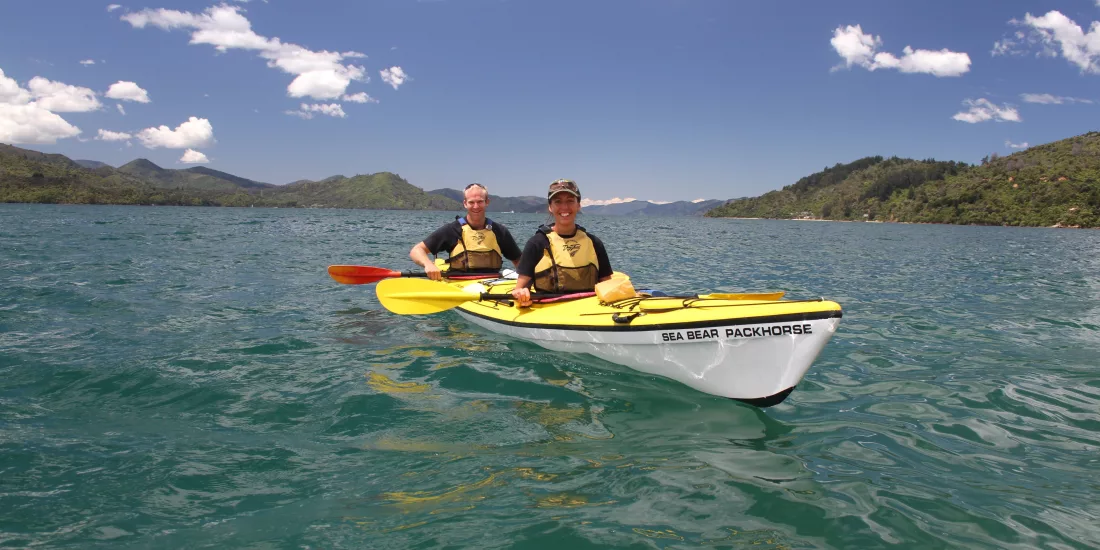 Two people in a tandem kayak during a Marlborough Sounds guided tour
