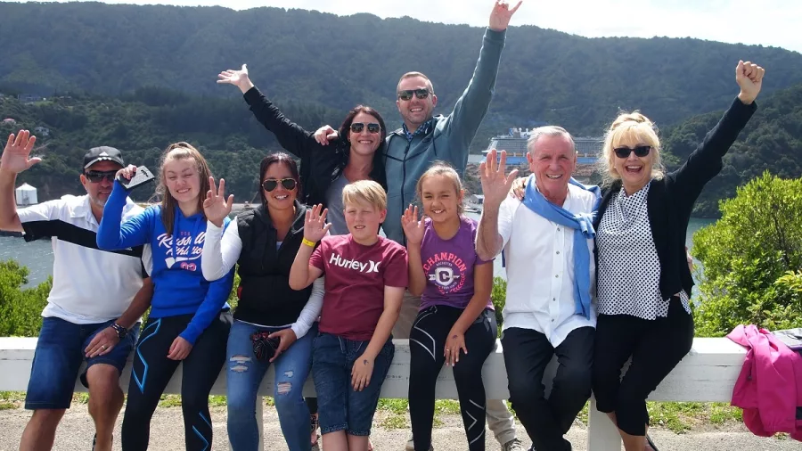 Cruise shore excursion group posing with scenic Marlborough backdrop near Picton.