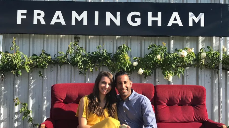Smiling couple seated outside at Framingham Wines vineyard in Marlborough.