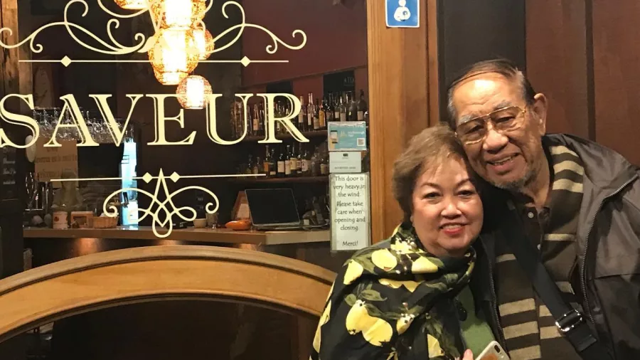 Smiling couple outside Saveur Café & Bistro in Blenheim, New Zealand.