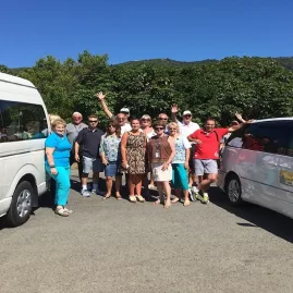 Tour group standing beside Your Local Chauffeur vans in Marlborough.
