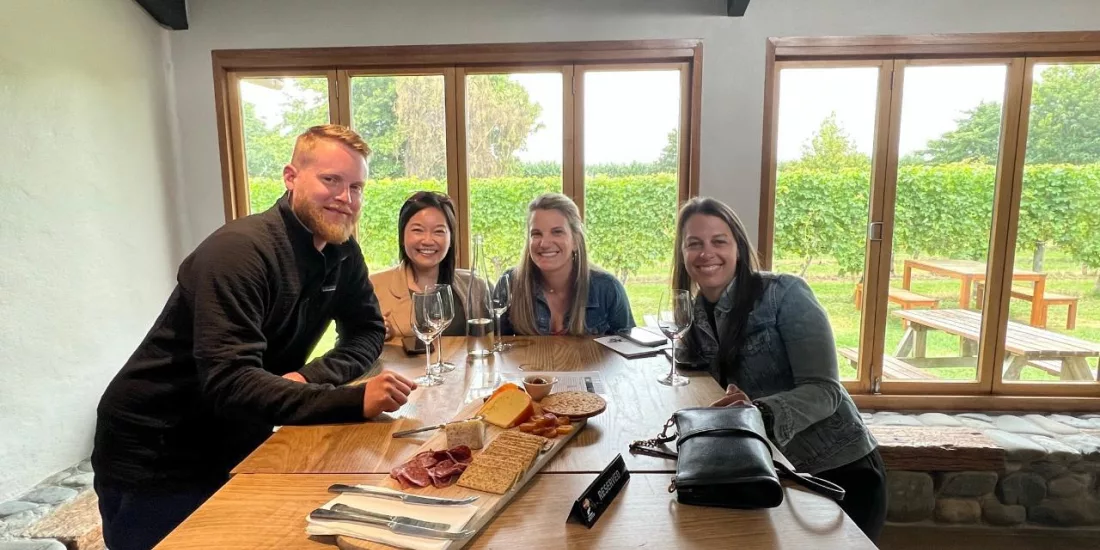 Group enjoying wine tasting and shared platter inside a Marlborough cellar door