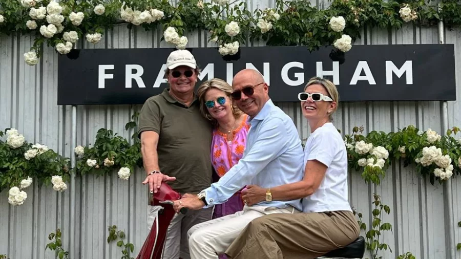 Wine tour group posing on a red scooter outside Framingham Wines