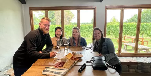 Group enjoying wine tasting and shared platter inside a Marlborough cellar door