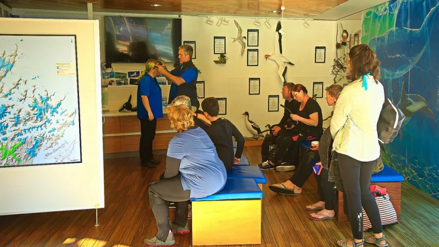 Guests receiving a pre-tour briefing inside the E-Ko Tours centre in Picton before a dolphin cruise.