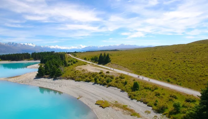 Cyclists riding along the Alps to Ocean Trail beside Lake Pukaki with mountain views in New Zealand