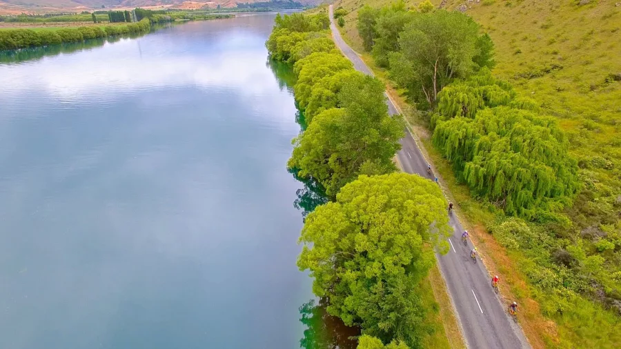 Cycling beside the calm waters of Lake Aviemore on the scenic Alps to Ocean Trail