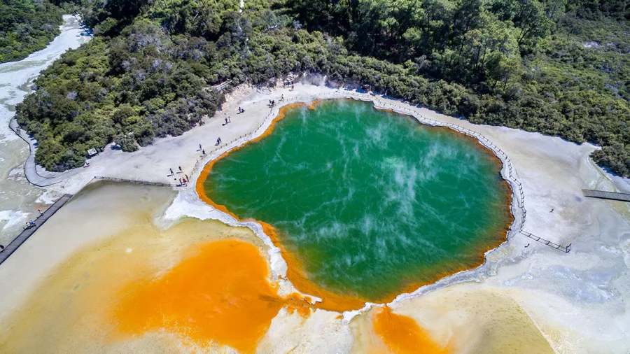 Aerial view of Champagne Pool at Wai-O-Tapu Thermal Wonderland in Rotorua, with vibrant orange and green geothermal colours.
