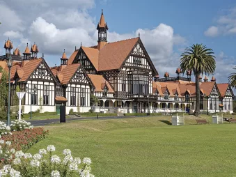 Historic Rotorua Museum with Tudor-style architecture set in the Government Gardens under a blue sky