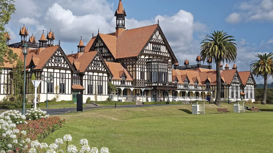 Historic Rotorua Museum with Tudor-style architecture set in the Government Gardens under a blue sky