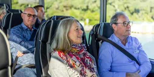 Passengers seated on Grand Pacific Tours’ Signature coach enjoying the scenic journey