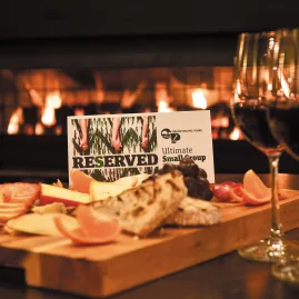 Charcuterie platter and wine served with a reserved sign for Ultimate Small Group Touring